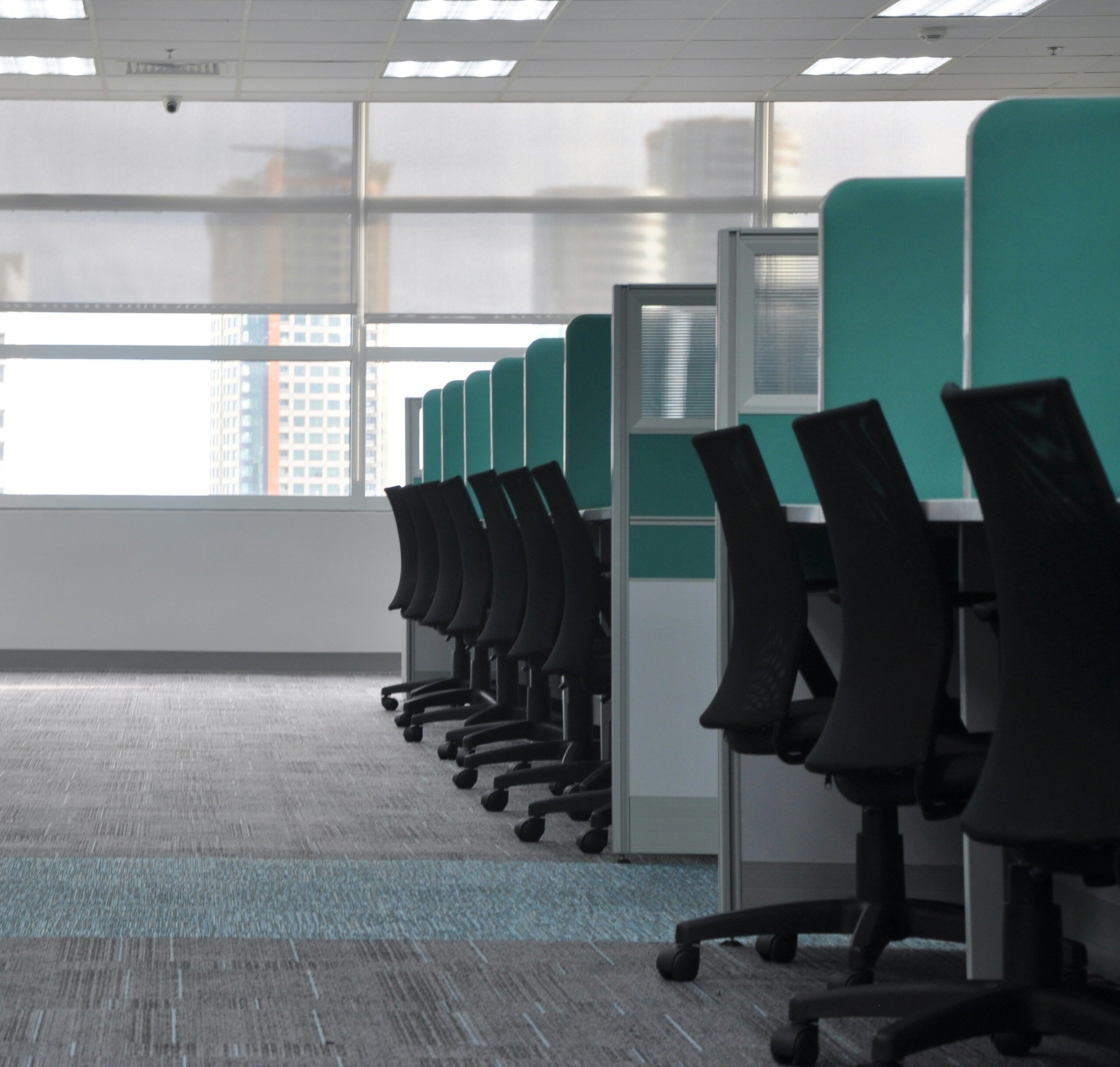 An empty contact center with chairs neatly tucked into each workstation.